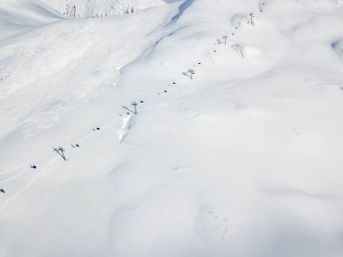 Aerial view of ski chairlift on snow covered mountain in Switzerland