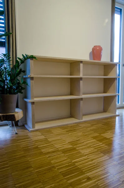 Empty bookshelf made of wood in flat at home