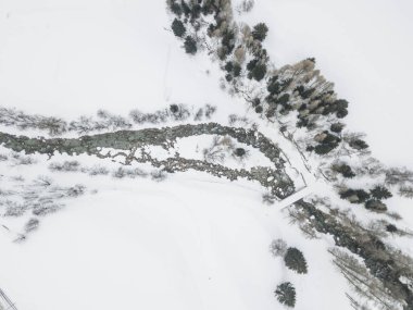 Aerial view of river through snow covered landscape in Switzerland