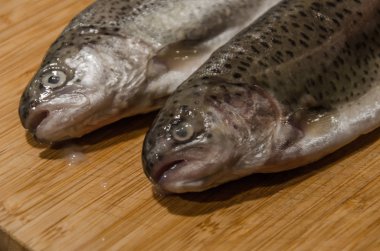 Gökkuşağı alabalığı ahşap masada pişmeye hazır. 