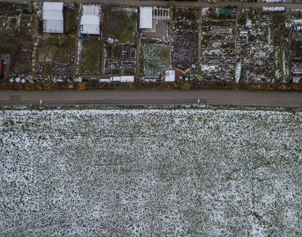 Aerial view of allotments in summer and winter. Photoshop montage of two different seasons with fade between summer and winter. Symbolizes change throughout the year in a eye-catching birds eye view.