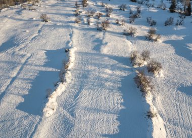 İsviçre 'de karla kaplı tarlaların hava görüntüsü.
