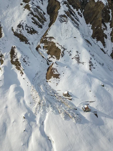 stock image Aerial view of snow avalanche on mountain slope.