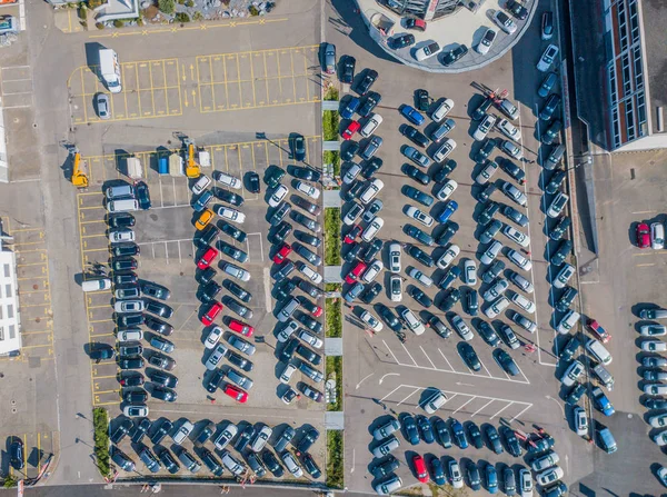Aerial view of car park with many car standing in chaotic order