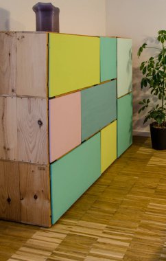 Giysiler için renkli kapıları olan şarap kutularından yapılmış ev yapımı dolap.