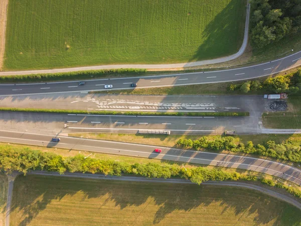 Aerial view of highway interchange on green meadow in Switzerland