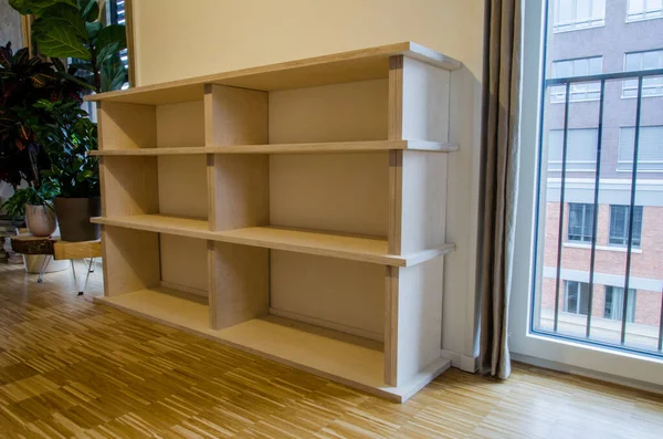 Empty bookshelf made of wood in flat at home