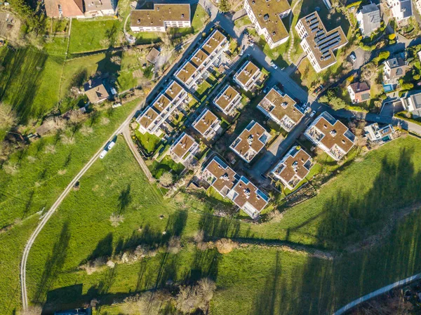 Aerial view of buildings at border of a town. Concept of urban sprawl in suburban area in Switzerland.