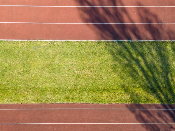 Aerial view of empty red running track.