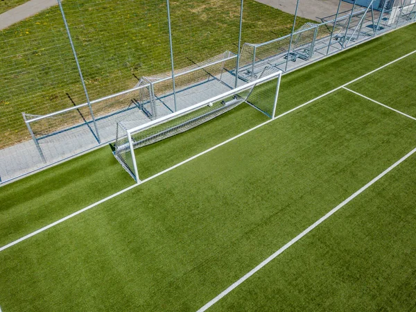 Aerial view of football goal and penalty area. Empty soccer field with white lines.