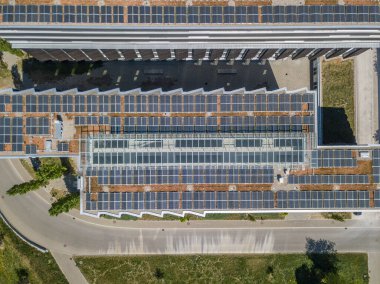 Elektrik üretimi için fotovoltaik paneli olan binaların çatılarının hava görüntüsü. Binalar için temiz enerji kavramı.