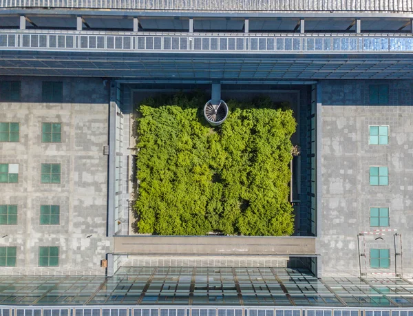 Aerial view of university building roof with green courtyard.  Concept of architecture for living.
