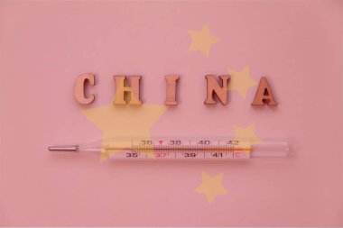China word of wooden letters with thermometer on backround with china flag: pandemic virus infection from Wuhan, China, novel Coronavirus outbreak. clipart