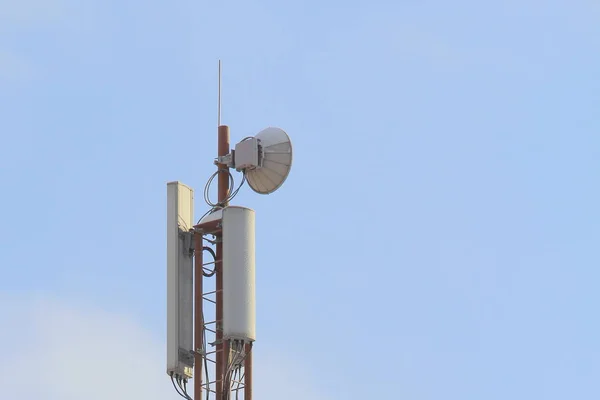 Base station mobile network antenna on a steel structure mast with a repeater.