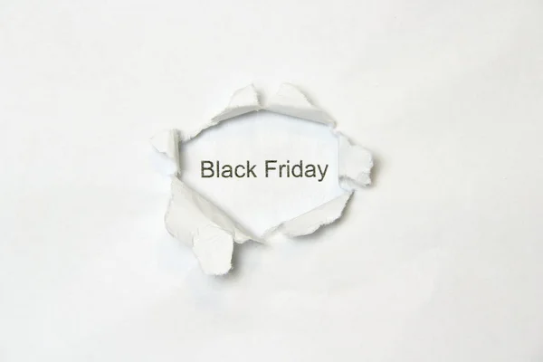 Word on white isolated background through the wound hole in the paper. — Stock Photo, Image