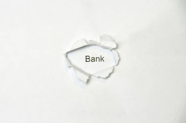 Palabra sobre fondo blanco aislado a través del orificio de la herida en el papel . — Foto de Stock