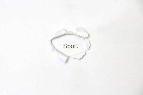 Palabra sobre fondo blanco aislado a través del orificio de la herida en el papel . — Foto de Stock