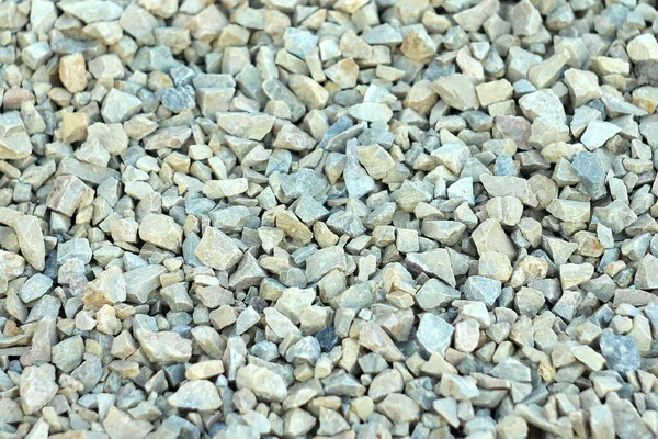 Achtergrond van blauw en grijs grind. Kleine stenen liggen op de grond op een bouwplaats. Kiezelpatroon op het strand — Stockfoto