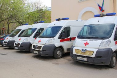 17-05-2020, Syktyvkar, Rusya. Rusya 'da bir şehir caddesinde kırmızı çizgili ve mavi ışıklı çok sayıda ambulans var.