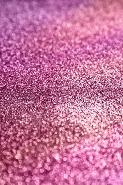 Pink glitter texture sparkling paper background. Abstract twinkled pink glittering background  with bokeh, defocused lights for Christmas holiday, banner, wedding invitation and greeting cards.