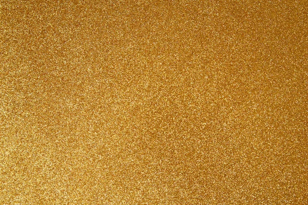 Gold glitter texture sparkling paper background. Abstract twinkled golden glittering background  with bokeh, defocused lights for Christmas holiday, banner, wedding invitation and greeting cards.