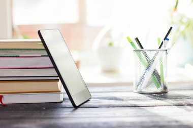 books and pc tablet on the table. study and prepare for exam. modern education concept.