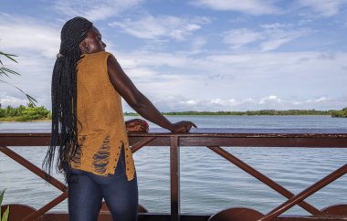 Afrikalı Gana 'lı kadın Batı Afrika' daki Volta nehri üzerindeki Ada Foah tatil beldesini ziyaret ediyor..
