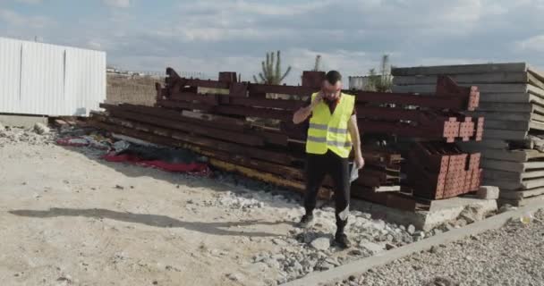 Man Construction Worker Engineer Who Walks Construction Site Checks Plan — Stock Video