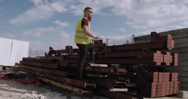 Working Man Engineer Walks Construction Site Plan Hand Checks Progress — Stock Video