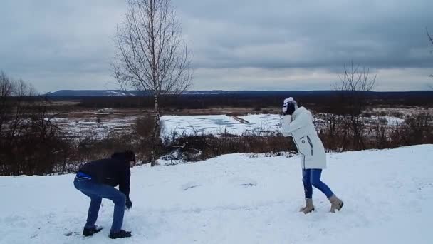 一对年轻夫妇在大自然中散步 玩雪球 玩得很开心 — 图库视频影像