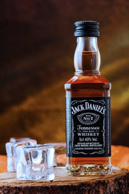 Bir şişe Jack Daniels viskisi siyah ve turuncu arka planda.