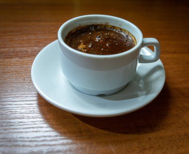 Tahta arka planda bir fincan kahve.