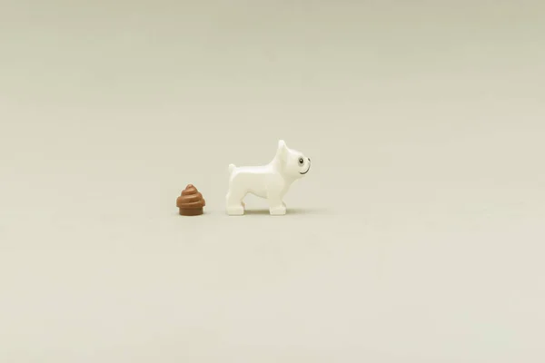 Side view of a minifigure of a Lego white dog with his poop — Stockfoto
