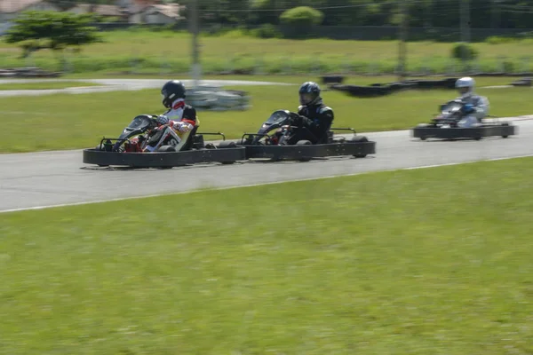 Dynamic image of three competitive, moving fast, go-karts — 스톡 사진