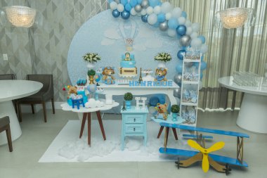 Mavimsi pastel renkli süslemeli bir çocuğun doğum günü partisi. Oyuncak ayılı, bulutlu, şekerli havacı temalı bir dekor. Zarif şeker masası ve güzel süslenmiş pasta..