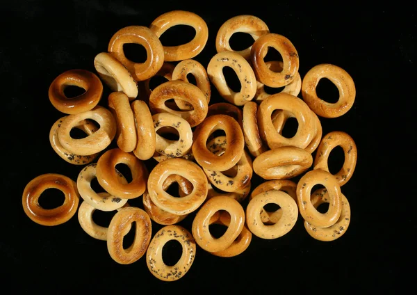 Drying bagels on a black background — Stock Photo, Image