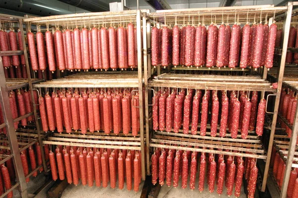 Loaves of sausage during the Smoking process