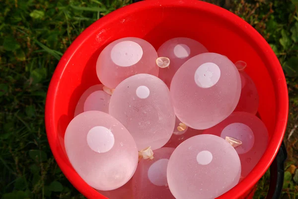 Water ballonnen in rode bekken — Stockfoto