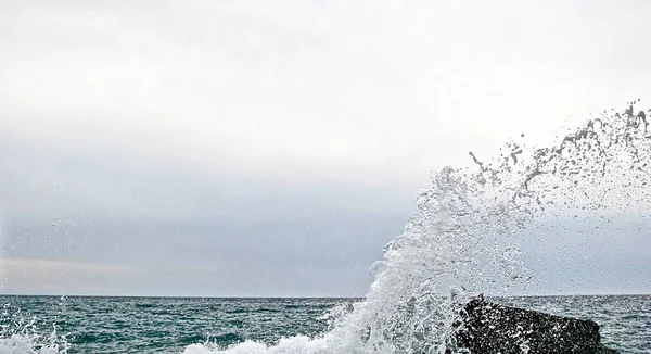 Alto spruzzo da un'onda marina che rompe la pietra — Foto Stock