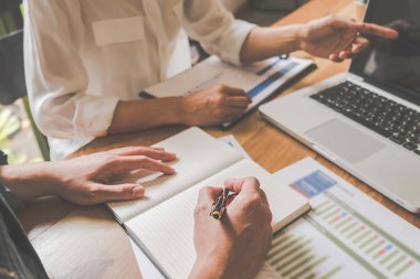 Ekonomik veriler ve rapor grafikleriyle beyin fırtınası yapıp tartışıyorlar. Takım çalışması çalışma konsepti.