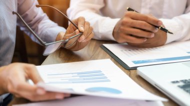 Ekonomik veriler ve rapor grafikleriyle beyin fırtınası yapıp tartışıyorlar. Takım çalışması çalışma konsepti.