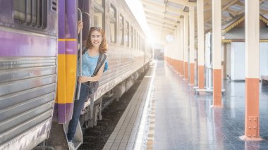 Tren istasyonunda bavullu bir gezgin kadın. Ulaşım için geleneksel tren.