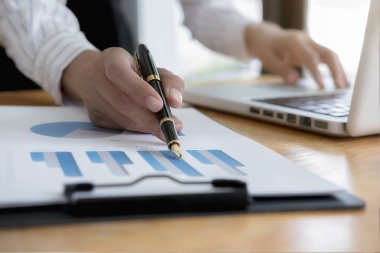 İş kadınları şirketin performans tablosunu kontrol etmek için dizüstü bilgisayar kullanıyor. İş konsepti.