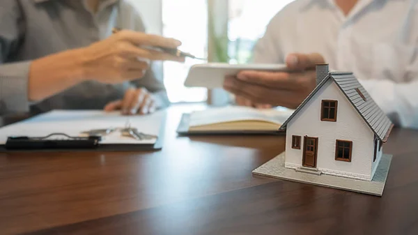 Modelo da casa com agente e cliente discutindo por contrato para comprar, obter seguro ou empréstimo imobiliário ou imóvel. — Fotografia de Stock