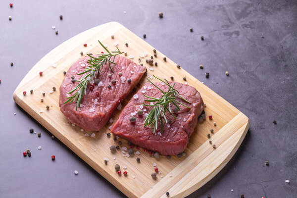 fresh raw sliced beef meat steak on a wooden board
