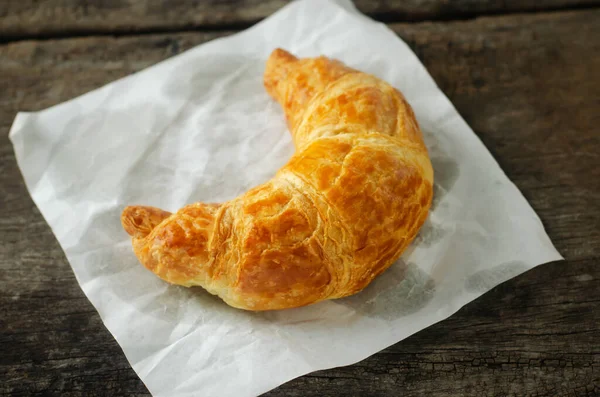 Närbild Croissant Med Vitt Papper Träbord — Stockfoto