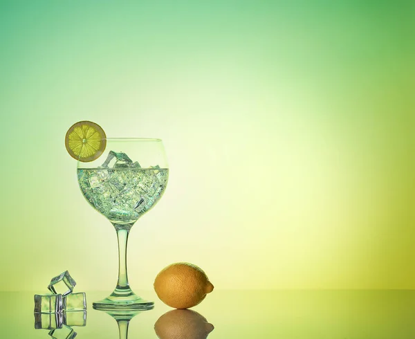 Gin tonic cocktail with limon and ice on a mirror background with copy space — 스톡 사진