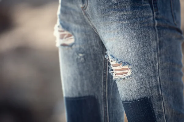 Holes in blue jeans — Stock Photo, Image