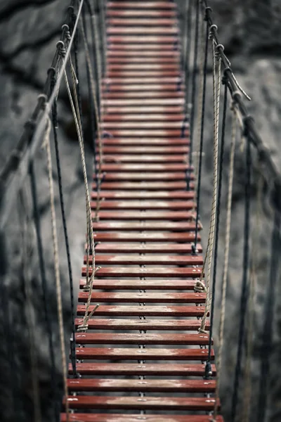 Suspension bridge in the mountains — Stock Photo, Image