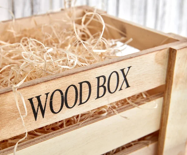 Wooden box with straw — Stock Photo, Image